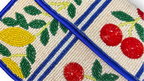 Beaded clutch with fruit patterns on a white background