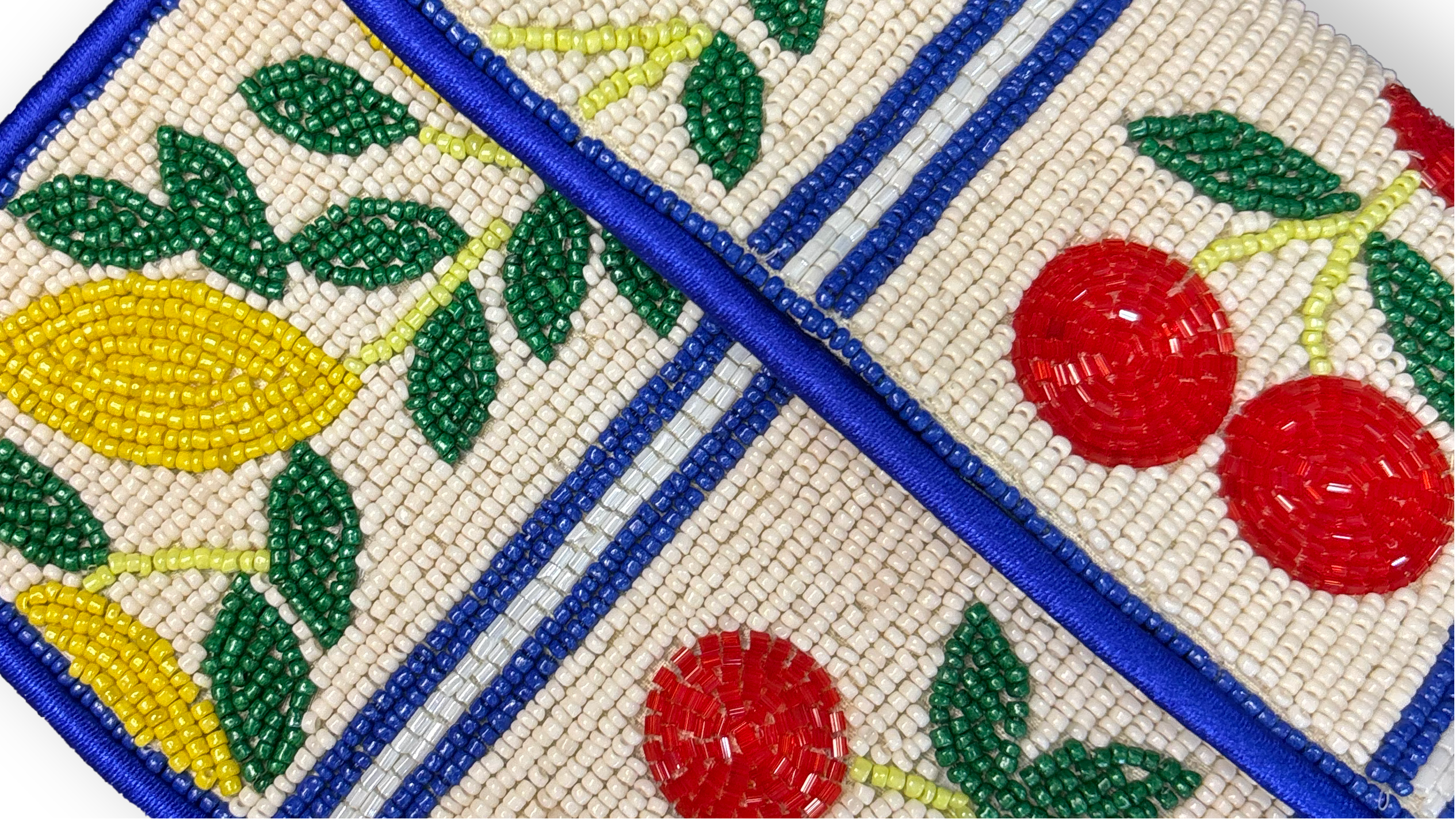 Beaded clutch with fruit patterns on a white background